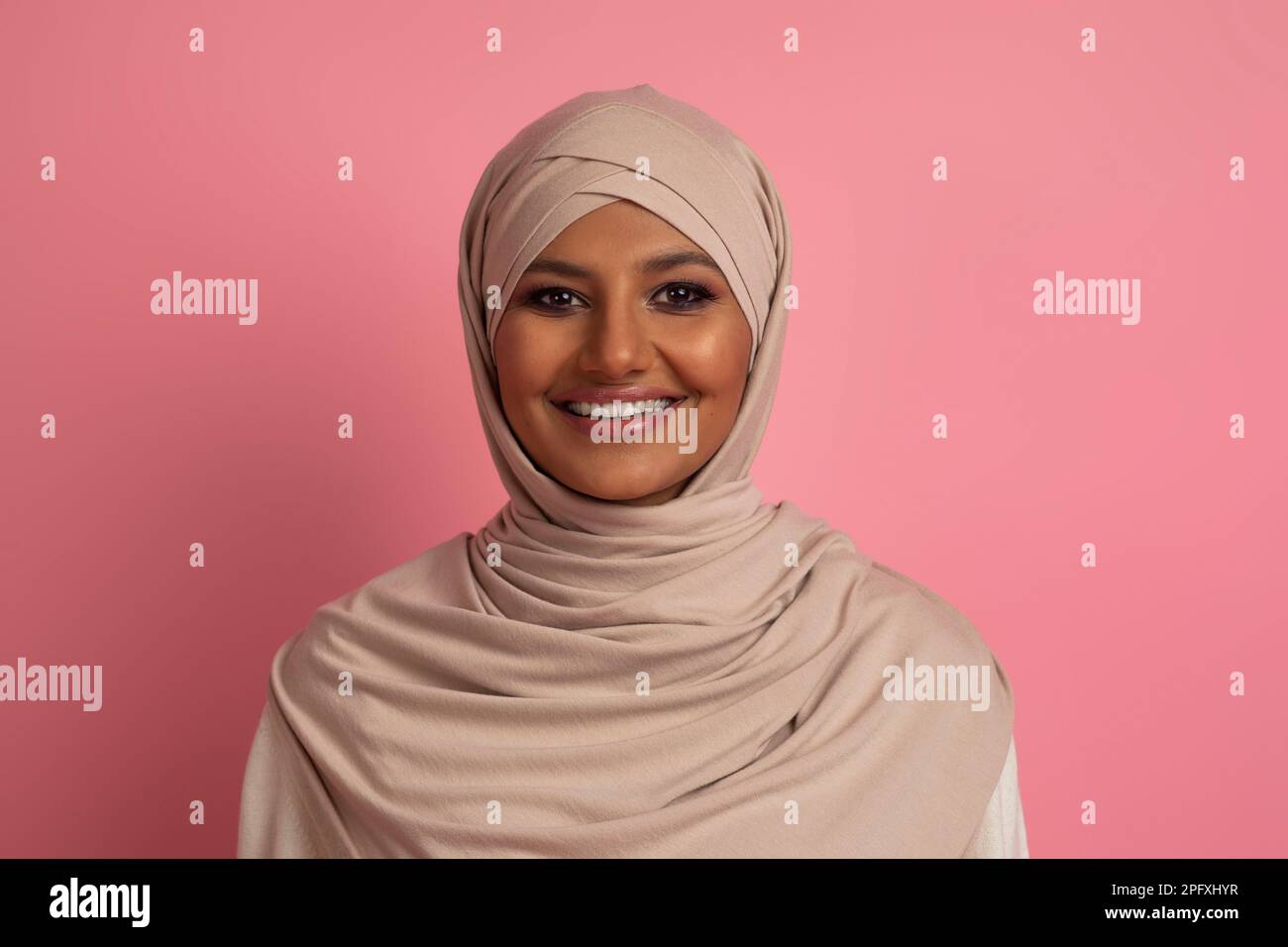 Portrait Of Beautiful Young Muslim Woman In Hijab Posing Over Pink ...