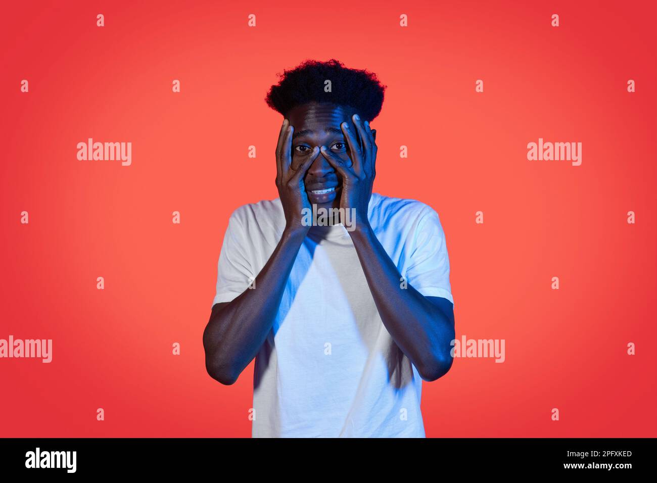 Frightened african american young man covering his face Stock Photo - Alamy