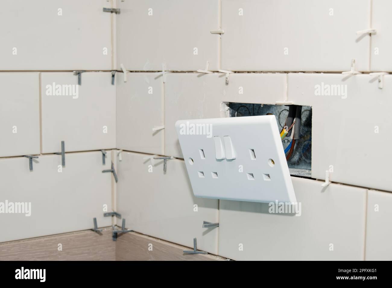 New tile installation in kitchen with electrical sockets removed Stock