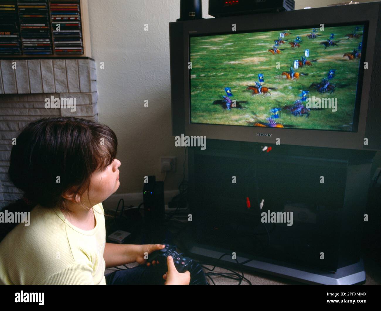Girl Playing on Computer Console Sony Playstation 2 Stock Photo