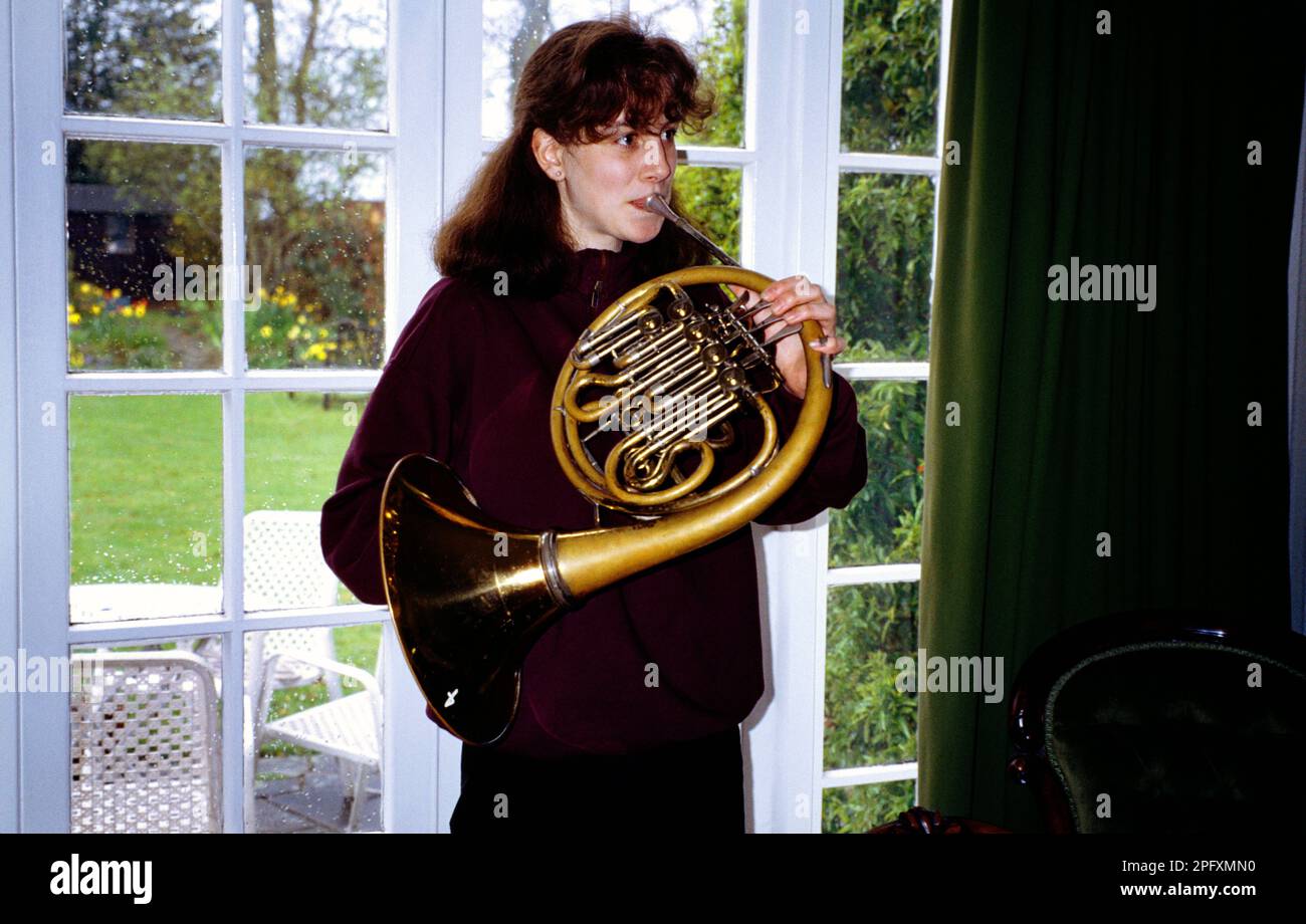 Teenage Girl Playing French Horn Stock Photo
