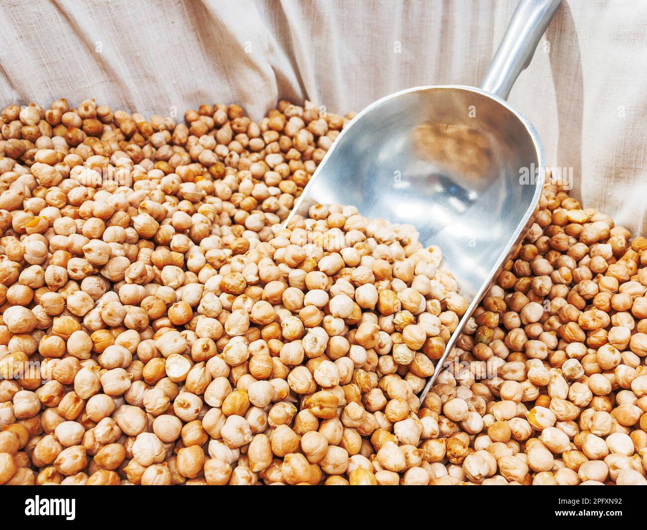 Box with chickpeas. A special scoop for sprinkling grits in packages ...