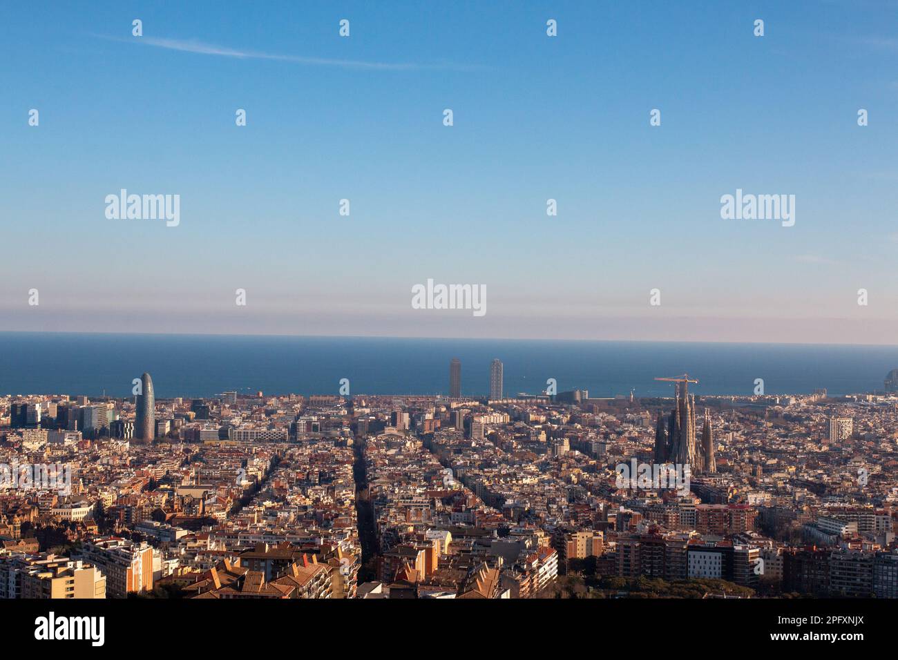 View of Barcelona, Spain from above,  with the ocean and clear blue skies in the background. Stock Photo