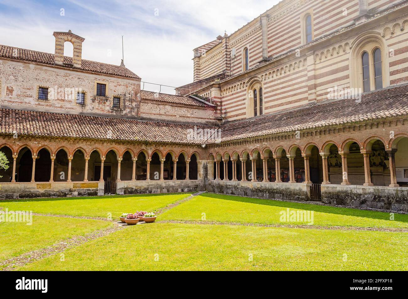 Cloister of San Zeno Cathedral showing ornate arches and carvings ...