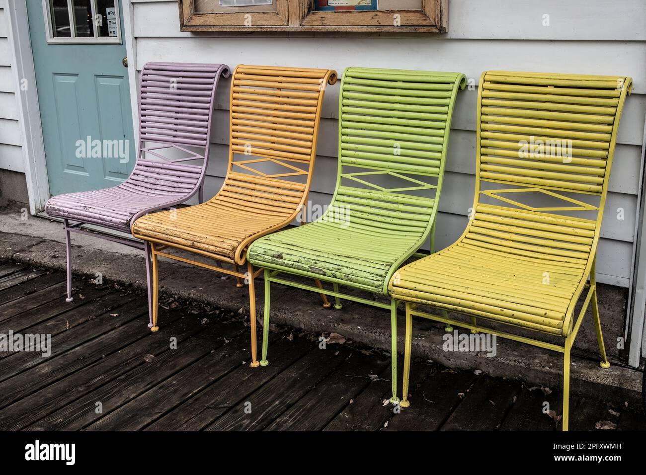 Mullticolored chairs; lilac, peach, lime green, yellow, outside for