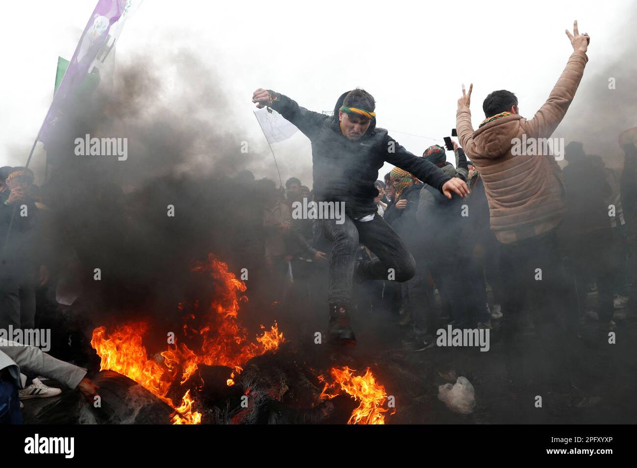 A man jumps over a bonfire during a rally to celebrate Nowruz, which marks the arrival of spring, in Istanbul, Turkey March 19, 2023. REUTERS/Murad Sezer Stock Photo