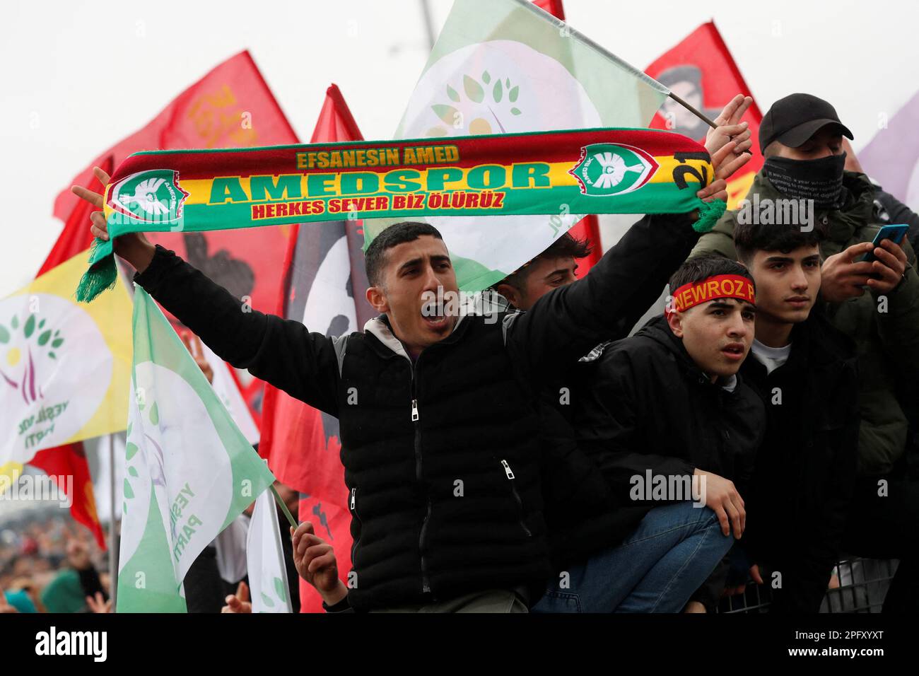 A man shouts slogans as he holds a scarf of Amedspor soccer team during a rally to celebrate Nowruz, which marks the arrival of spring, in Istanbul, Turkey March 19, 2023. REUTERS/Murad Sezer Stock Photo