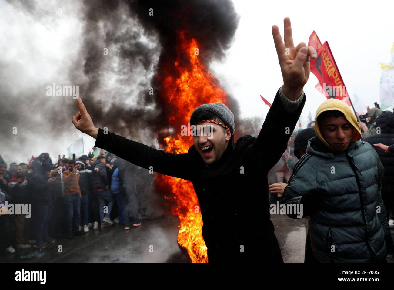 A man flashes V-signs after jumping over a bonfire during a rally to celebrate Nowruz, which marks the arrival of spring, in Istanbul, Turkey March 19, 2023. REUTERS/Murad Sezer Stock Photo
