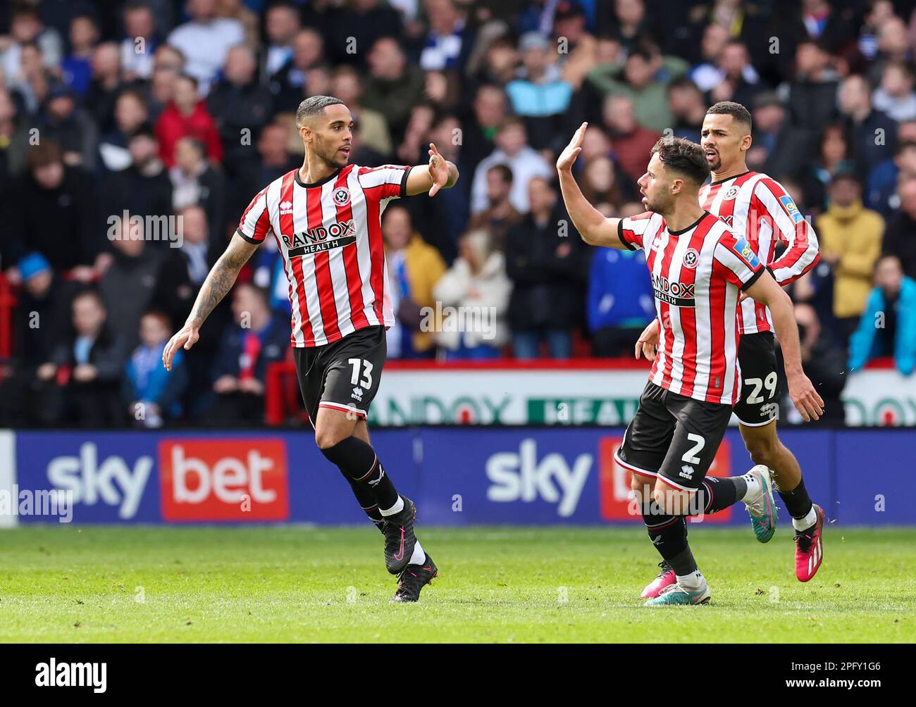 Bramall Lane, Sheffield, UK. 19th Mar, 2023. FA Cup Football, Quarter Final, Sheffield United versus Blackburn Rovers; Sheffield United's Max Lowe celebrates with a high five from George Baldock and Iliman Ndiaye running to join them after his shot was deflected by Blackburn Rovers' Sam Gallagher for an own goal to make the score 1-1 in the 28th minute Credit: Action Plus Sports/Alamy Live News Stock Photo
