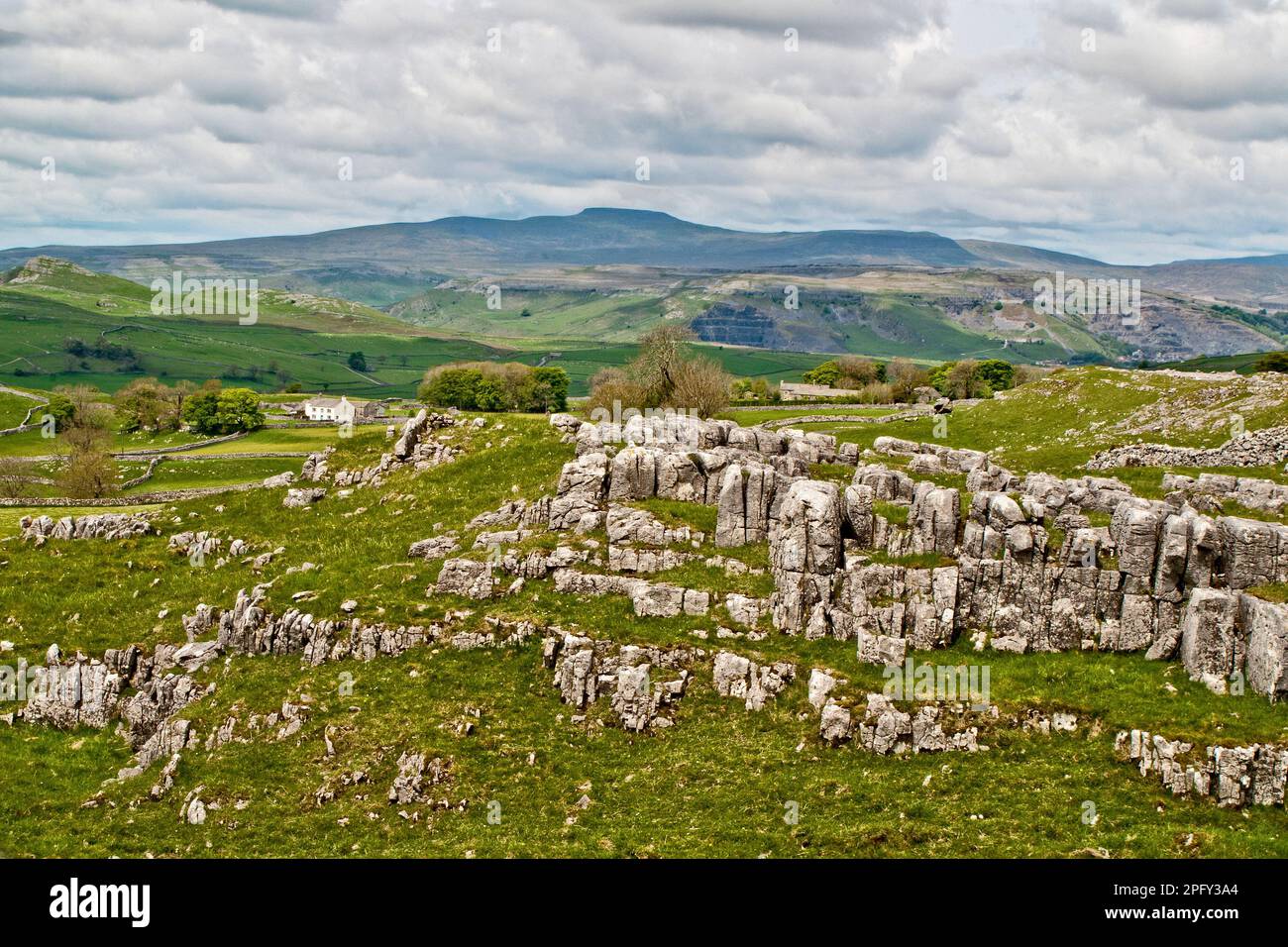The long rise to Ingleborough can be seen clearly from Winskill in beautiful limestone scenery. Stock Photo
