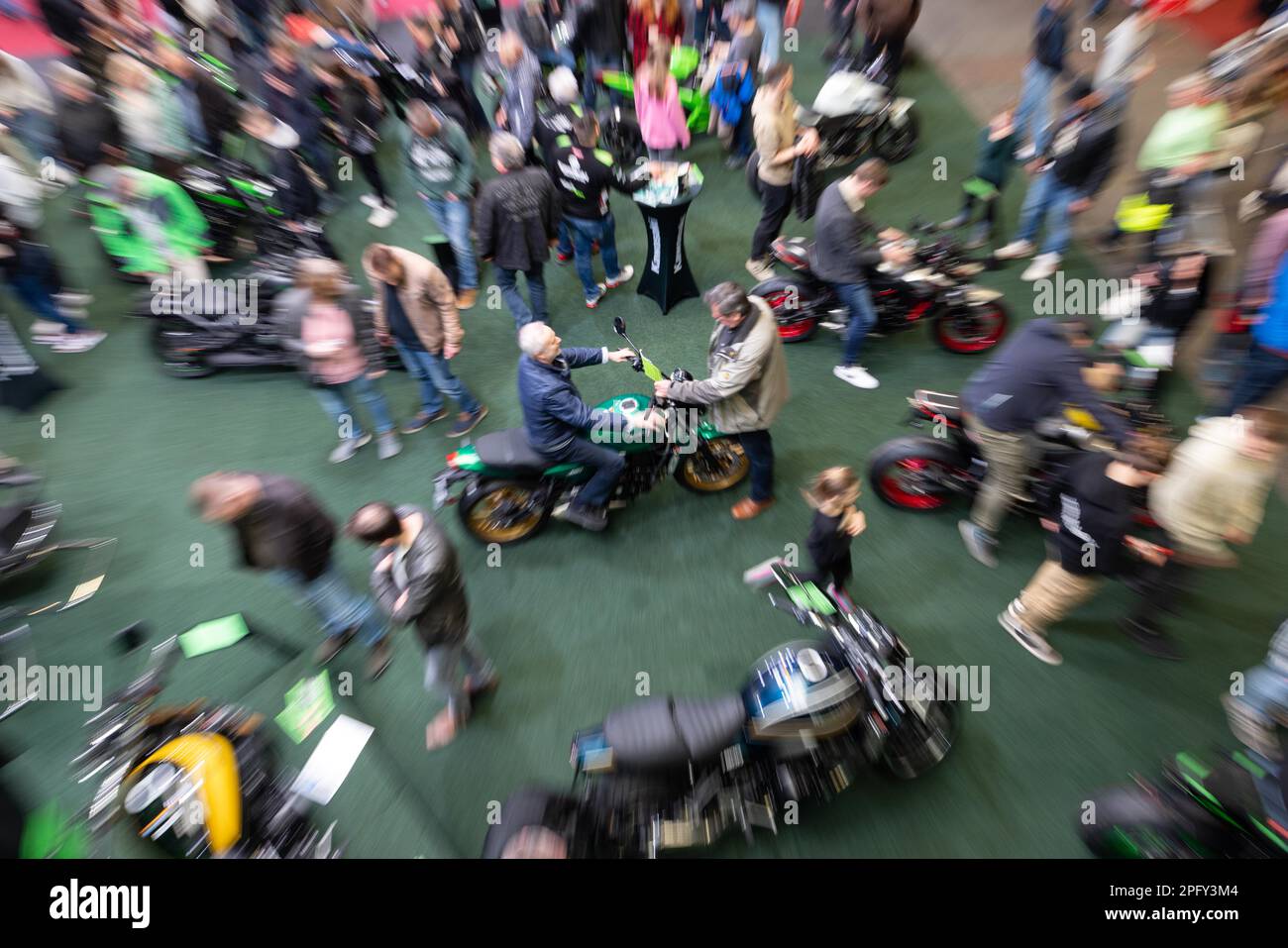 Erfurt, Germany. 19th Mar, 2023. Visitors look at the two-wheelers on display at the 23rd Erfurt Motorcycle Show. Around 100 exhibitors show everything about motorcycles, scooters, quads and trikes on 18,000 square meters of exhibition space. The organizer expects a new record number of visitors at the 23rd edition of the fair. Credit: Michael Reichel/dpa/Alamy Live News Stock Photo