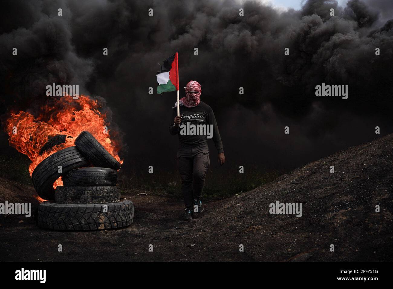 Gaza, Palestine. 19th Mar, 2023. (INT) The rebel youth ignites rubber