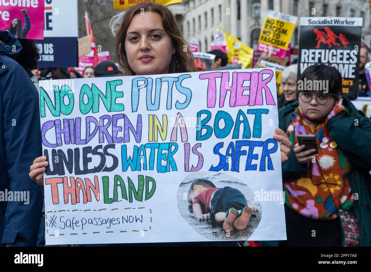 London, UK. 18th March, 2023. A human rights campaigner holds a sign calling for safe passage for asylum seekers during a Resist Racism demonstration organised by Stand Up To Racism and the Trades Union Congress (TUC) as part of a global day of action against racism. Speakers expressed their anger at and opposition to the government’s controversial Illegal Migration Bill. Credit: Mark Kerrison/Alamy Live News Stock Photo