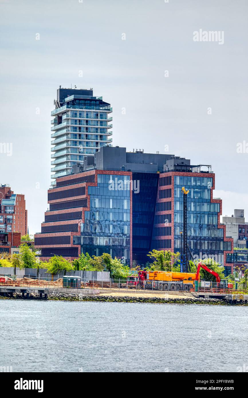 25 Kent Avenue is a full-block mid-rise commercial development in North Williamsburg. The stepped, brick-faced blocks have glass end caps. Stock Photo