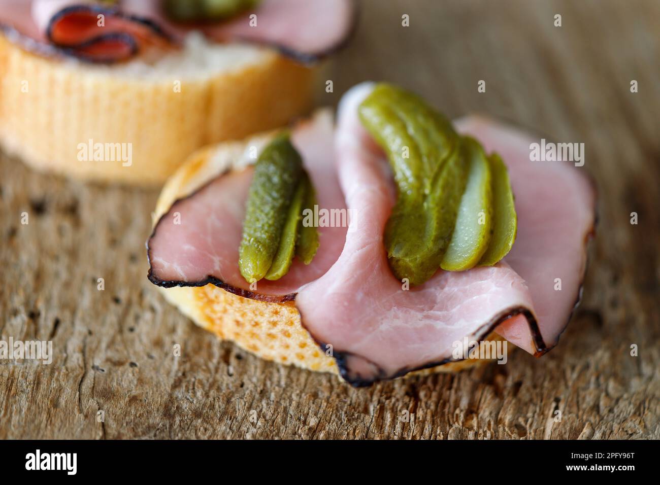 ham sandwich with gherkin on wood Stock Photo