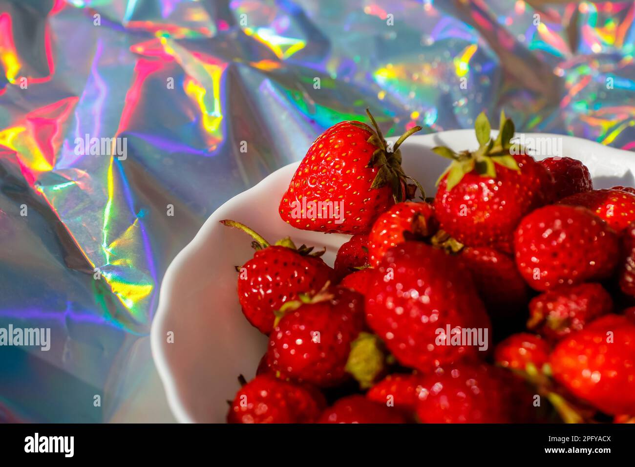 Strawberry festival. Close-up cropped bowl of ripe red strawberries on modern hologram background. Fruits and berries. Harvest and crop concept. Organ Stock Photo