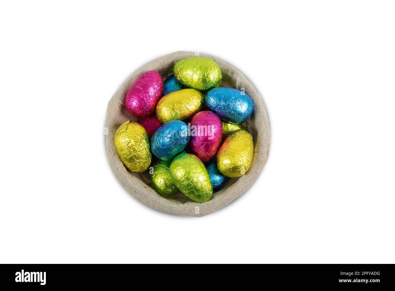 Chocolate Easter eggs in a basket isolated on white. Stock Photo