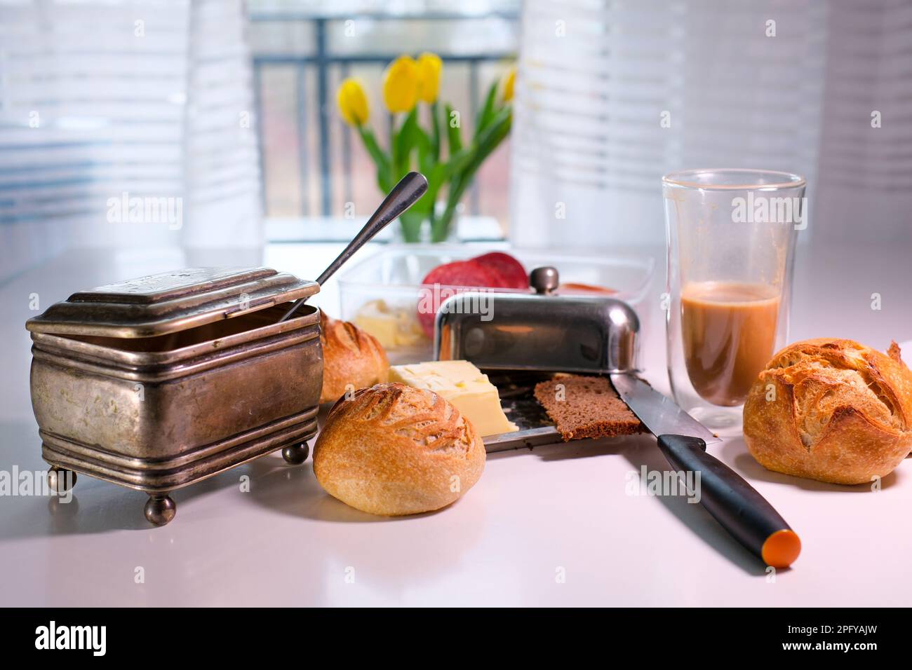delicious breakfast on table fresh buns knife half cup of drunk coffee ...