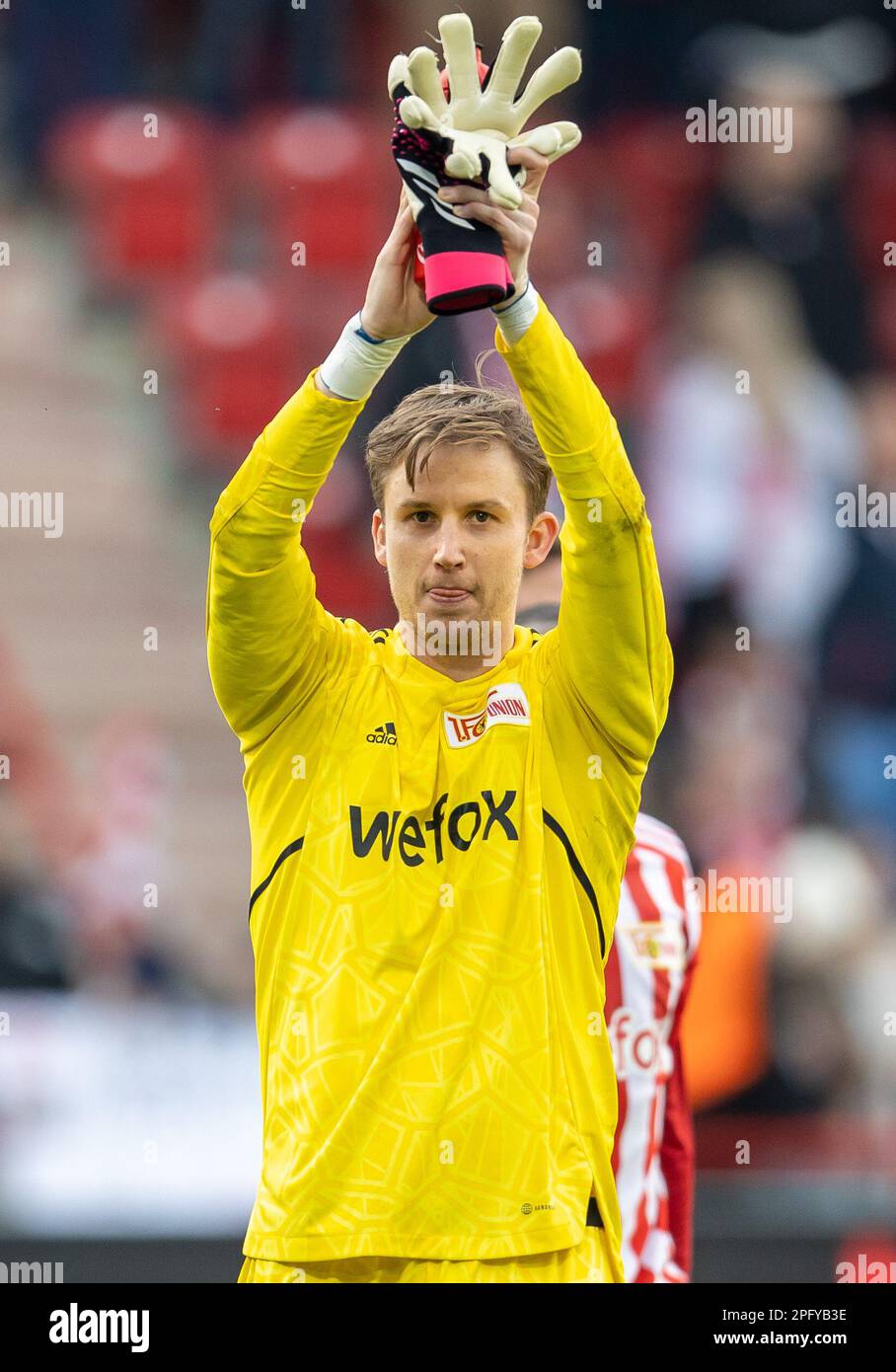 Berlin, Germany. 19th Mar, 2023. Soccer: Bundesliga, 1. FC Union Berlin - Eintracht Frankfurt, Matchday 25, An der Alten Försterei. Union goalkeeper Frederik Rönnow thanks the crowd after the win. Credit: Andreas Gora/dpa - IMPORTANT NOTE: In accordance with the requirements of the DFL Deutsche Fußball Liga and the DFB Deutscher Fußball-Bund, it is prohibited to use or have used photographs taken in the stadium and/or of the match in the form of sequence pictures and/or video-like photo series./dpa/Alamy Live News Stock Photo