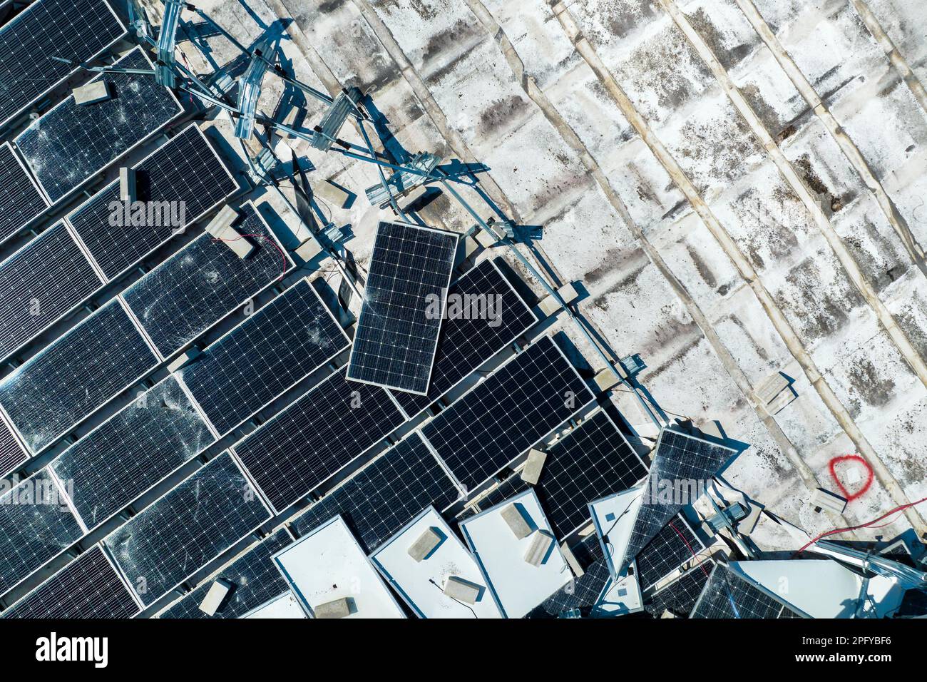 Aerial view of damaged by hurricane wind photovoltaic solar panels