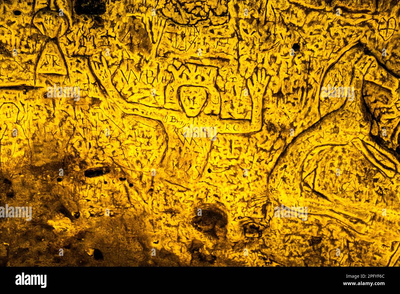 Royston Cave in Herfordshire U.K. still puzzles historians today. The cave is decorated with a large number of low-relief wall sculptures. They are mainly Christian motifs in the medieval style. At the top left is depicted a crucifixion scene. Royston Cave in Katherine's Yard, Melbourn Street, Royston, England Stock Photo