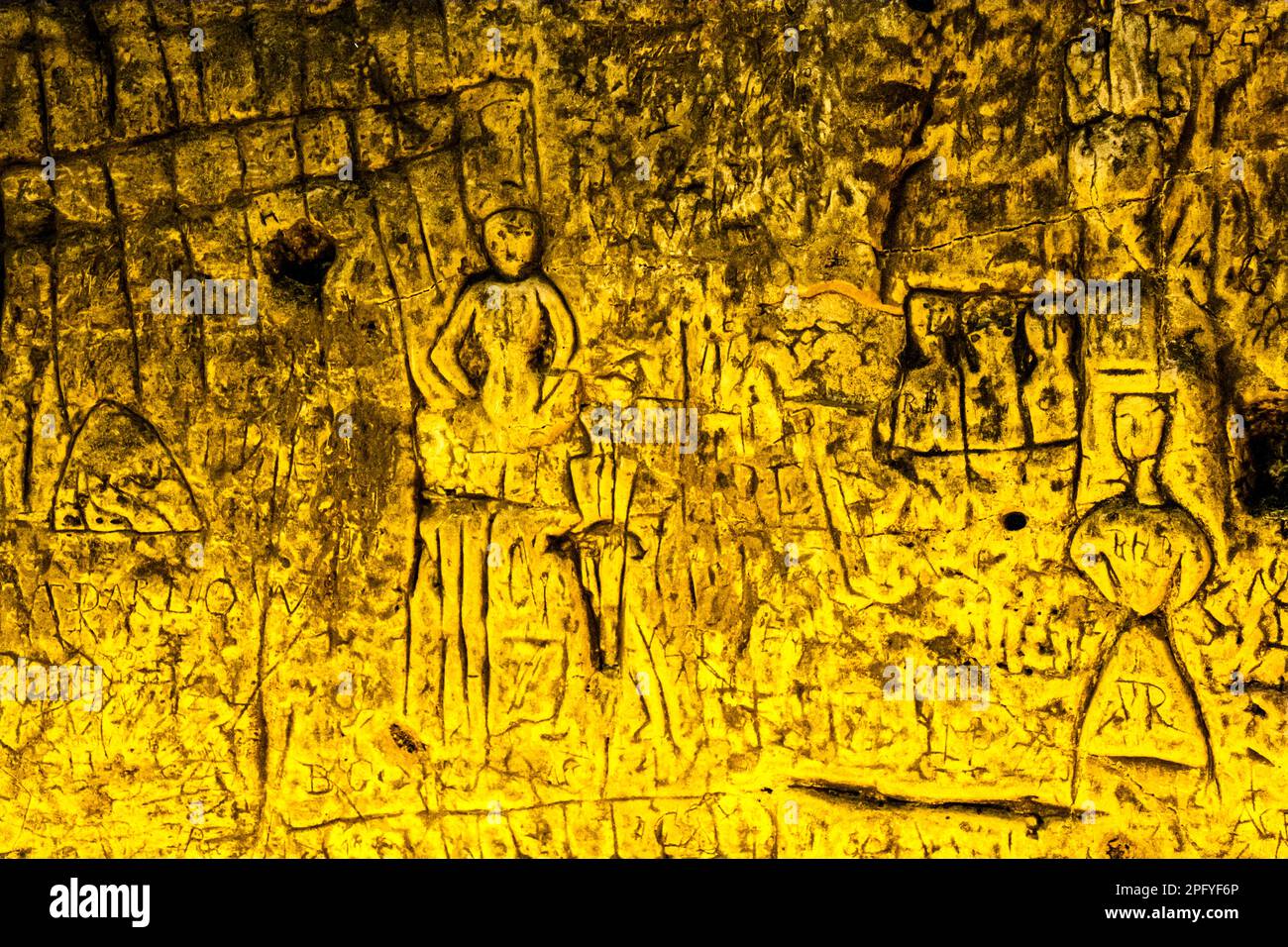 Royston Cave in Herfordshire U.K. still puzzles historians today. The cave is decorated with a large number of low-relief wall sculptures. They are mainly Christian motifs in the medieval style. At the top left is depicted a crucifixion scene. Royston Cave in Katherine's Yard, Melbourn Street, Royston, England Stock Photo