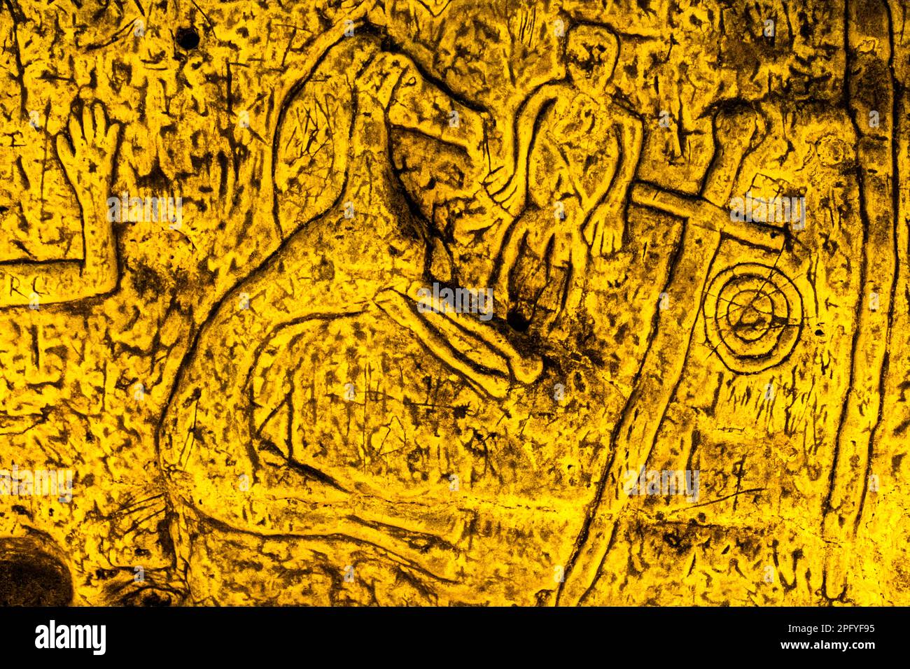 Royston Cave in Herfordshire U.K. still puzzles historians today. The cave is decorated with a large number of low-relief wall sculptures. They are mainly Christian motifs in the medieval style. At the top left is depicted a crucifixion scene. Royston Cave in Katherine's Yard, Melbourn Street, Royston, England Stock Photo