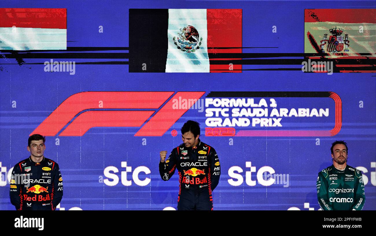 Formula One F1 - Saudi Arabian Grand Prix - Jeddah Corniche Circuit, Jeddah, Saudi Arabia - March 19, 2023 Red Bull's Sergio Perez stands on the podium after winning the Saudi Arabian Grand Prix alongside second placed Red Bull's Max Verstappen and third placed Aston Martin's Fernando Alonso before he is handed a 10 second time penalty that drops him to fourth in the final results REUTERS/Hamad I Mohammed Stock Photo