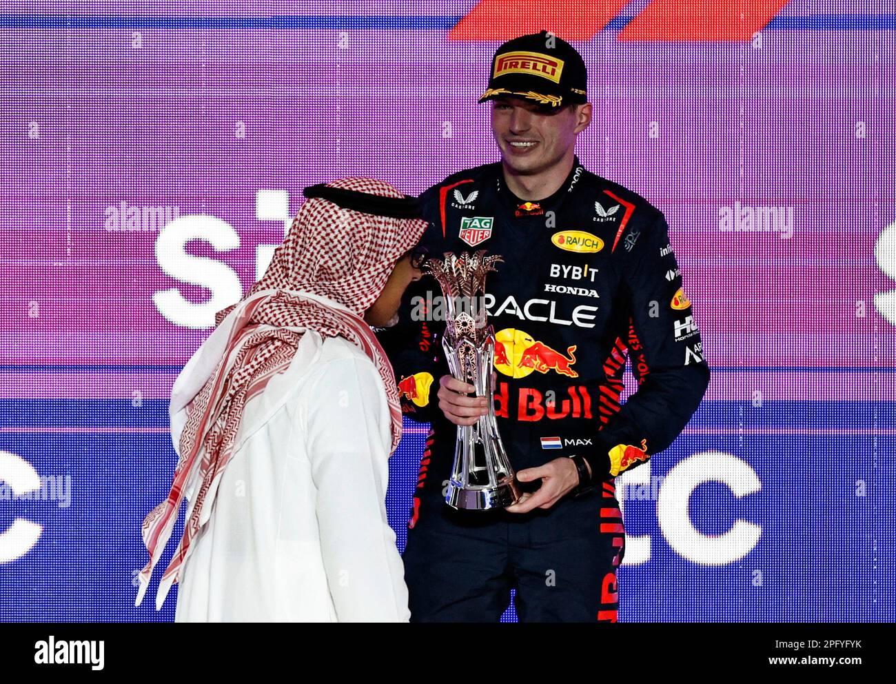 Formula One F1 - Saudi Arabian Grand Prix - Jeddah Corniche Circuit, Jeddah, Saudi Arabia - March 19, 2023 Red Bull's Max Verstappen celebrates with a trophy on the podium after finishing second place in the Saudi Arabian Grand Prix REUTERS/Hamad I Mohammed Stock Photo