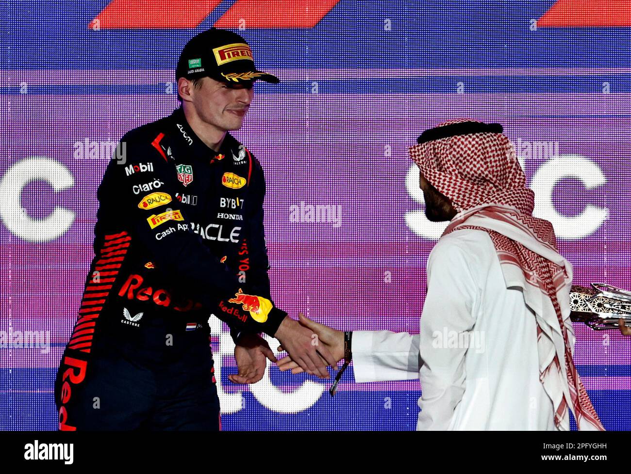 Formula One F1 - Saudi Arabian Grand Prix - Jeddah Corniche Circuit, Jeddah, Saudi Arabia - March 19, 2023 Saudi sports minister Prince Abdul Aziz bin Turki Al-Faisal shakes hands with second placed Red Bull's Max Verstappen on the podium after presenting a trophy to winner Red Bull's Sergio Perez REUTERS/Hamad I Mohammed Stock Photo