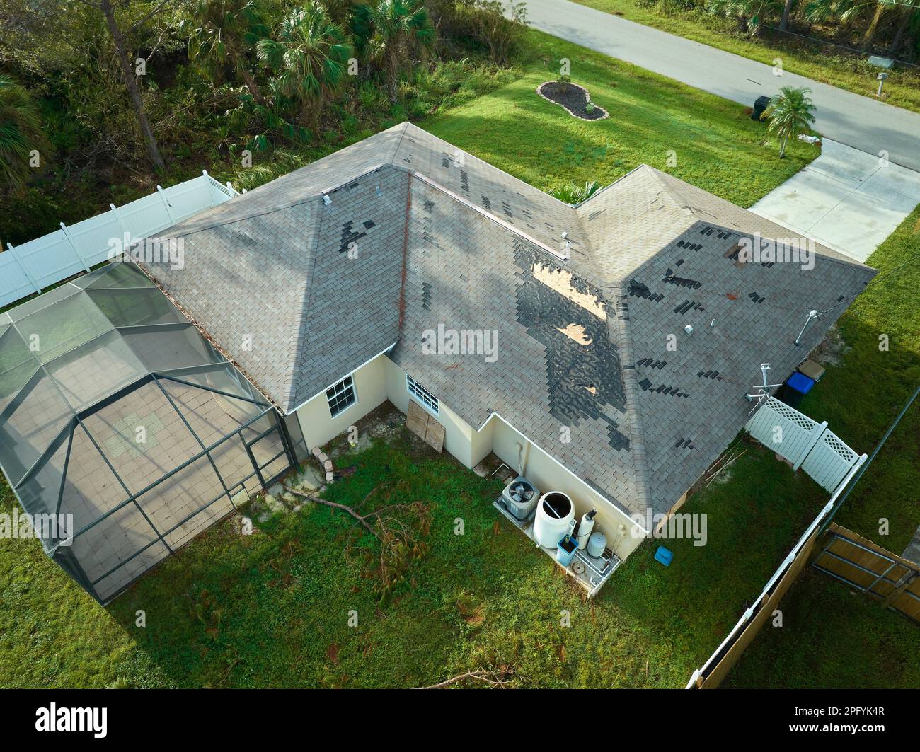 Hurricane Ian destroyed house roof in Florida residential area. Natural ...