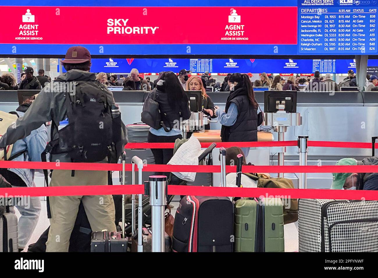 Queens, United States. 08th Mar, 2023. Passengers wait to check in and drop luggage at Terminal