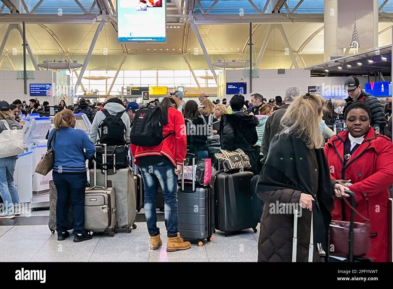 Queens, United States. 08th Mar, 2023. Passengers wait to check in and drop luggage at Terminal
