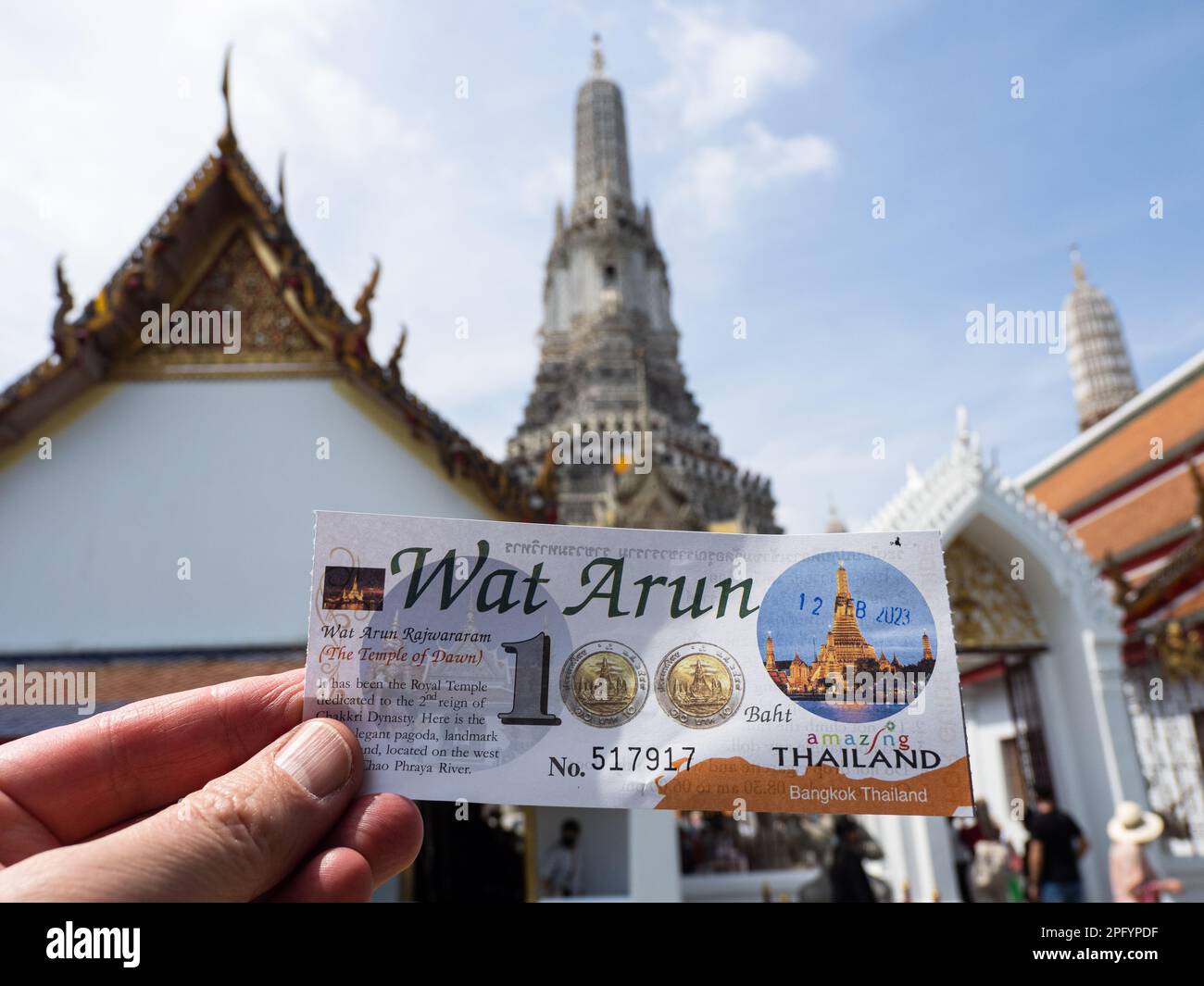 This is a Hundred Baht entrance ticket to Wat Arun Temple in Bangkok, Thailand, featuring the temple's iconic spires in the background. Wat Arun is a Stock Photo
