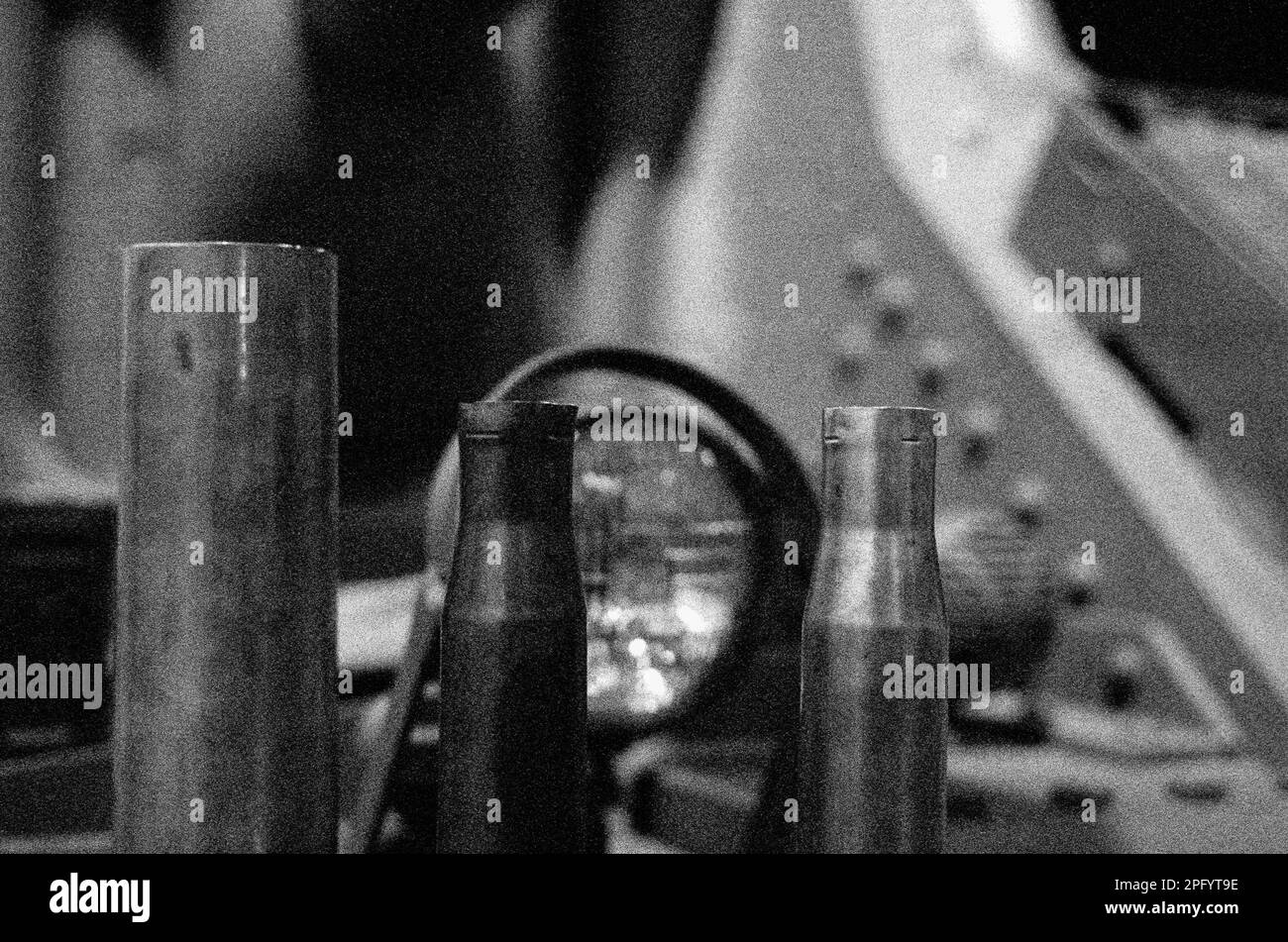 Three spent brass shells in a row resting on a tank at the American