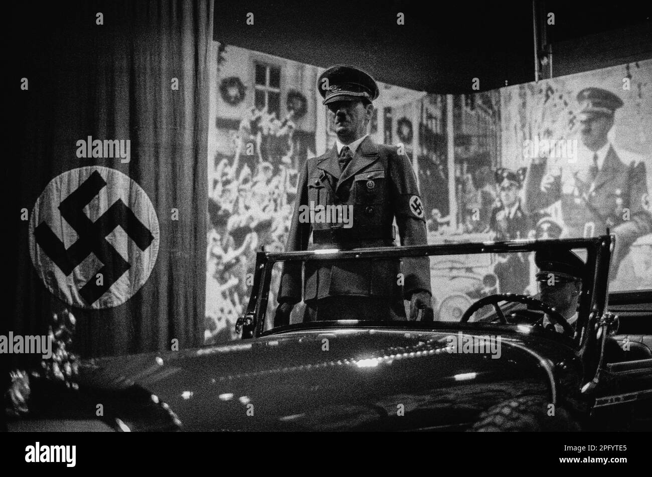 A replica figure of Adolf Hitler stands in his vintage Mercedes 770 automobile with animations of crowds saluting him during WWII at the American Heri Stock Photo