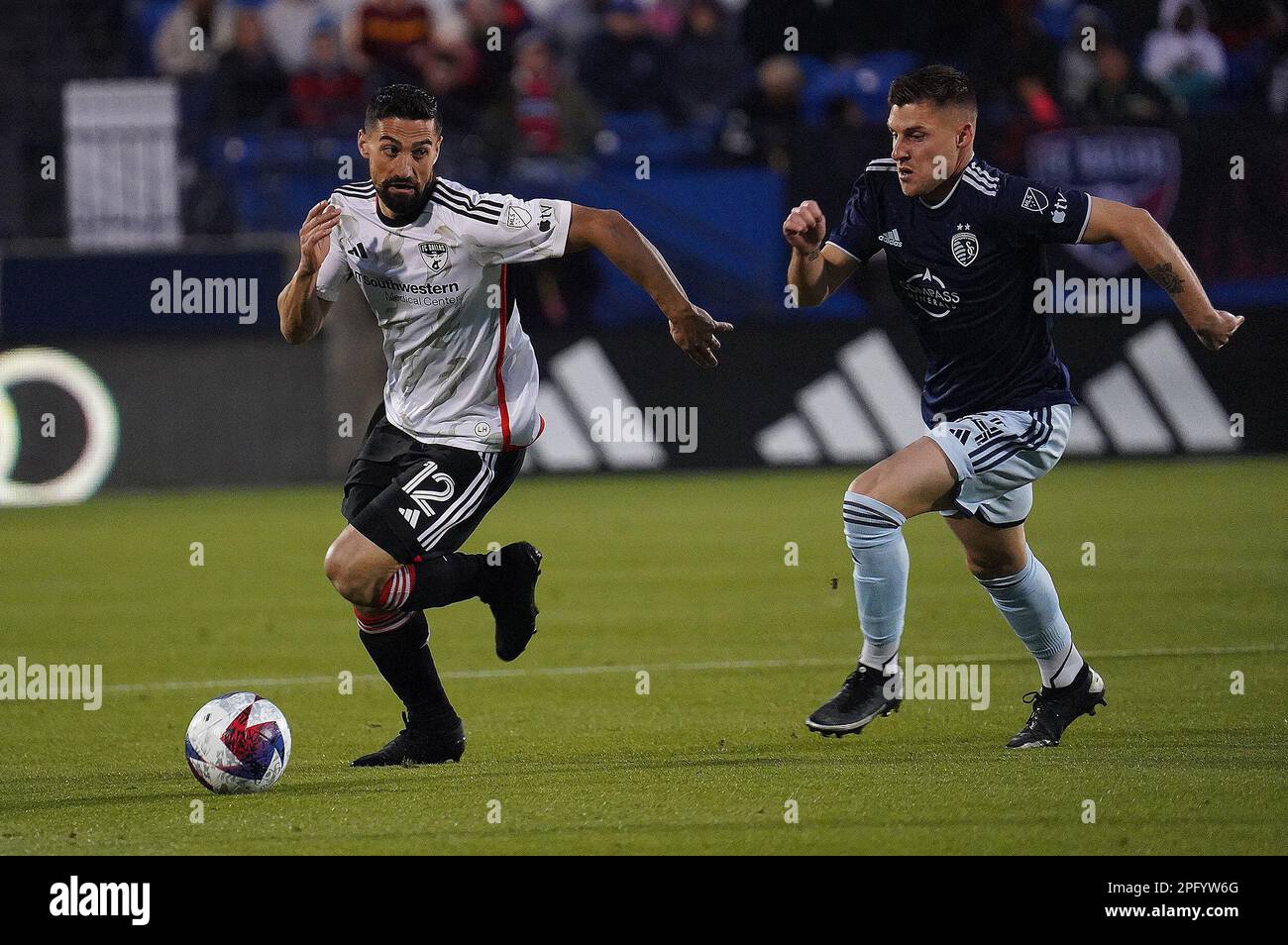 Frisco, United States. 18th Mar, 2023. March 18, 2023, Frisco, United States: FC Dallas midfielder Sebastian Lletget is chased by Sporting KC midfielder Remi Walter during first half action of the MLS game between FC Dallas and Sporting KC at Toyota Stadium on March 18, 2023 in Frisco, Texas. (Photo by Javier Vicencio/ Credit: Eyepix Group/Alamy Live News Stock Photo