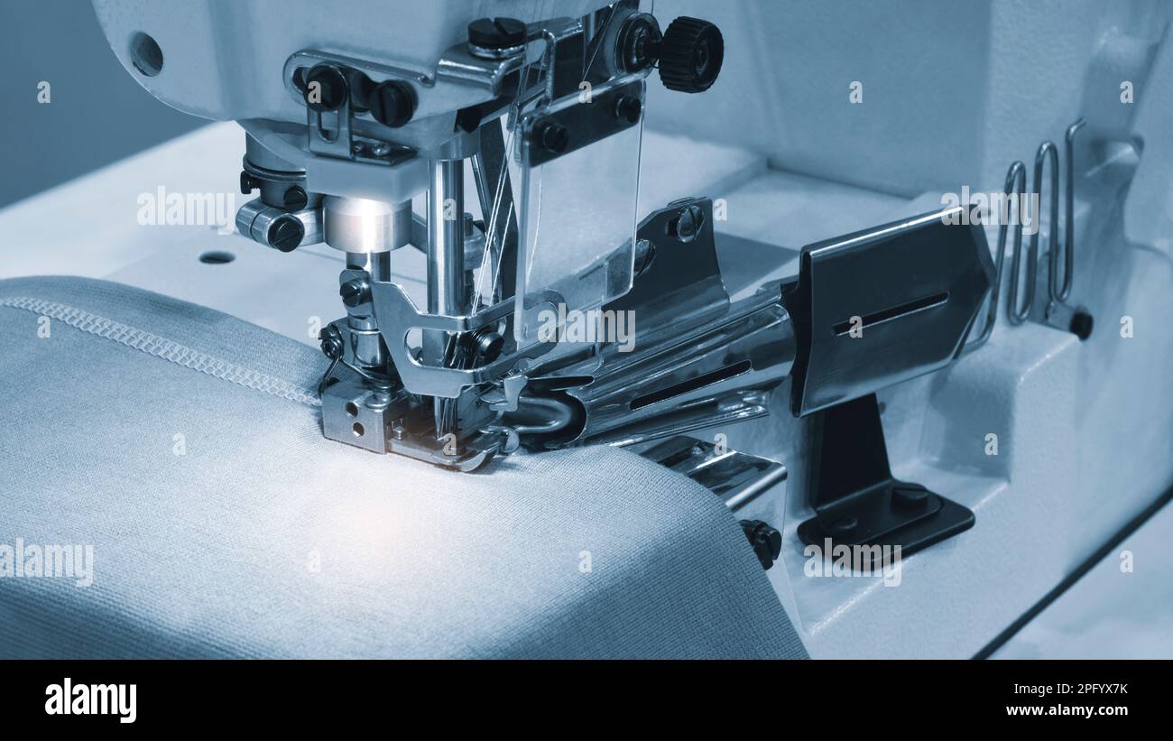 Sewing Factory Background Professional sewing machine and sews garments, textile fabric ...
