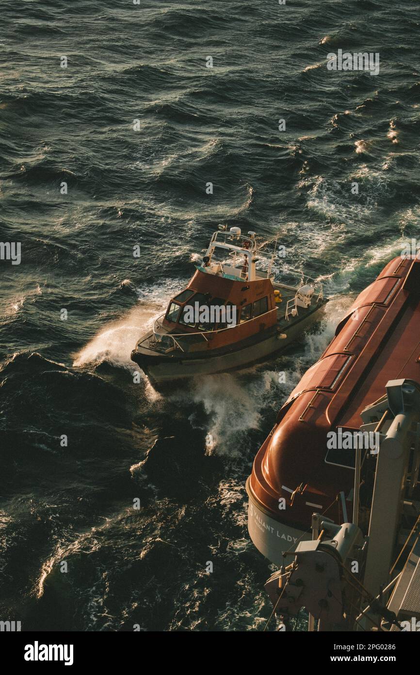 Tug boat guiding ship hi-res stock photography and images - Alamy
