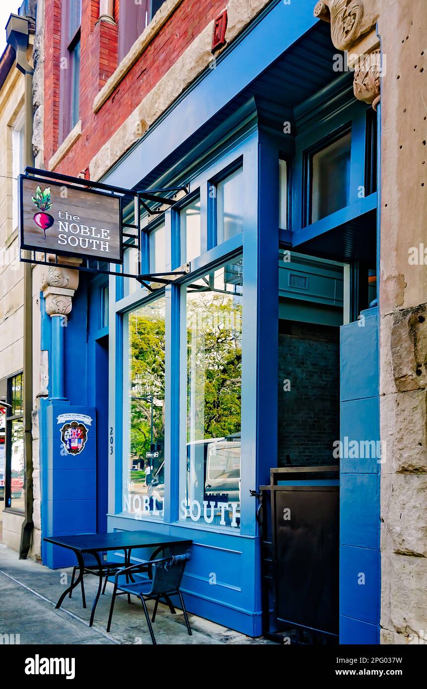 Tables line the sidewalk in front of The Noble South restaurant on