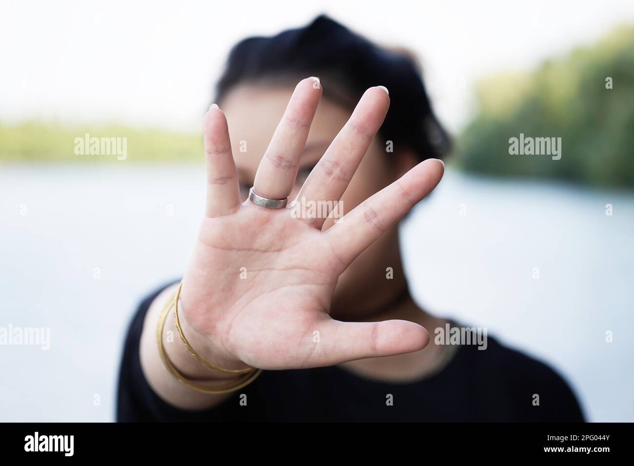 woman hiding face behind hand. defense reaction Stock Photo
