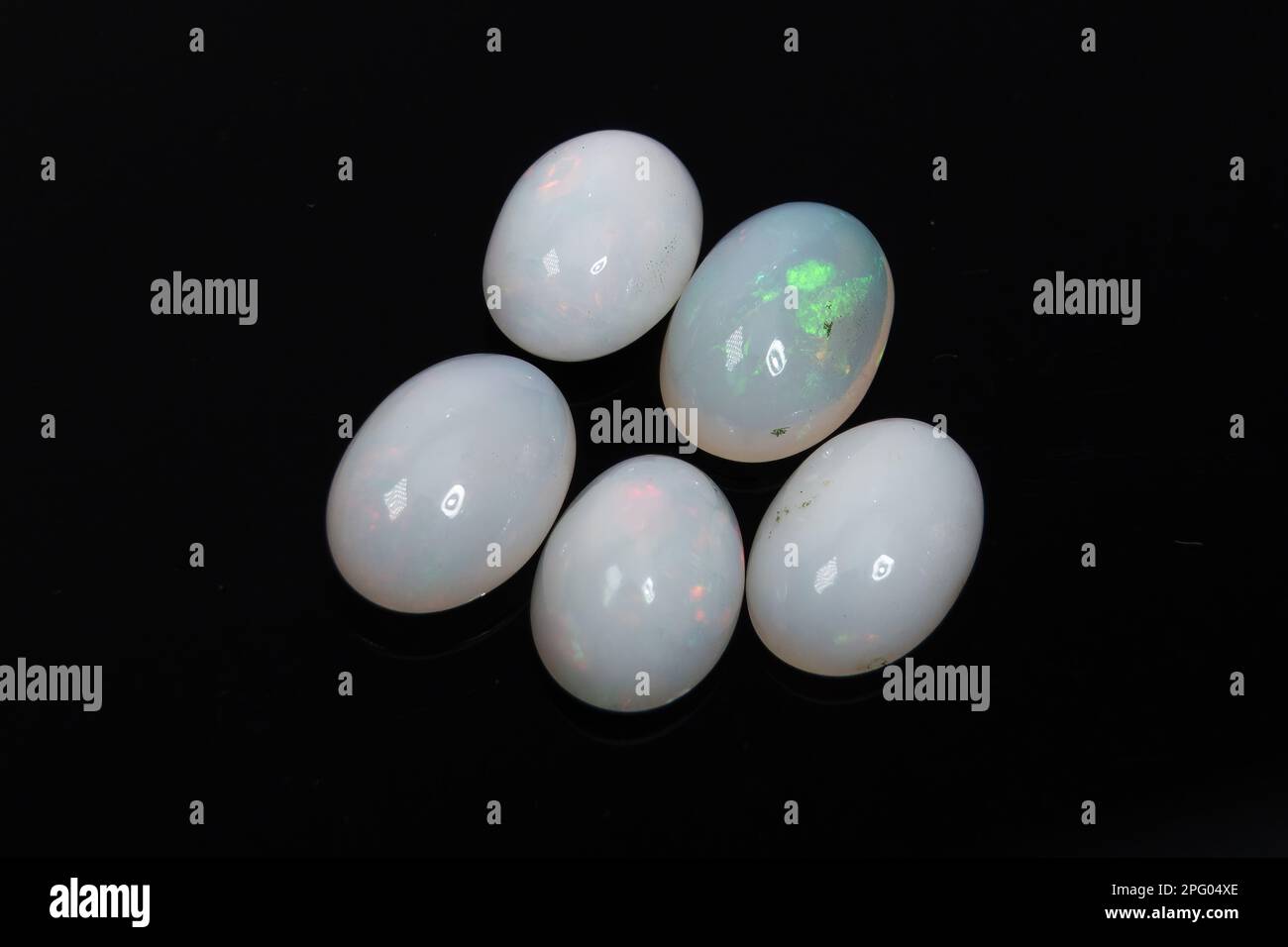 Natural precious stone noble opal on a black background Stock Photo