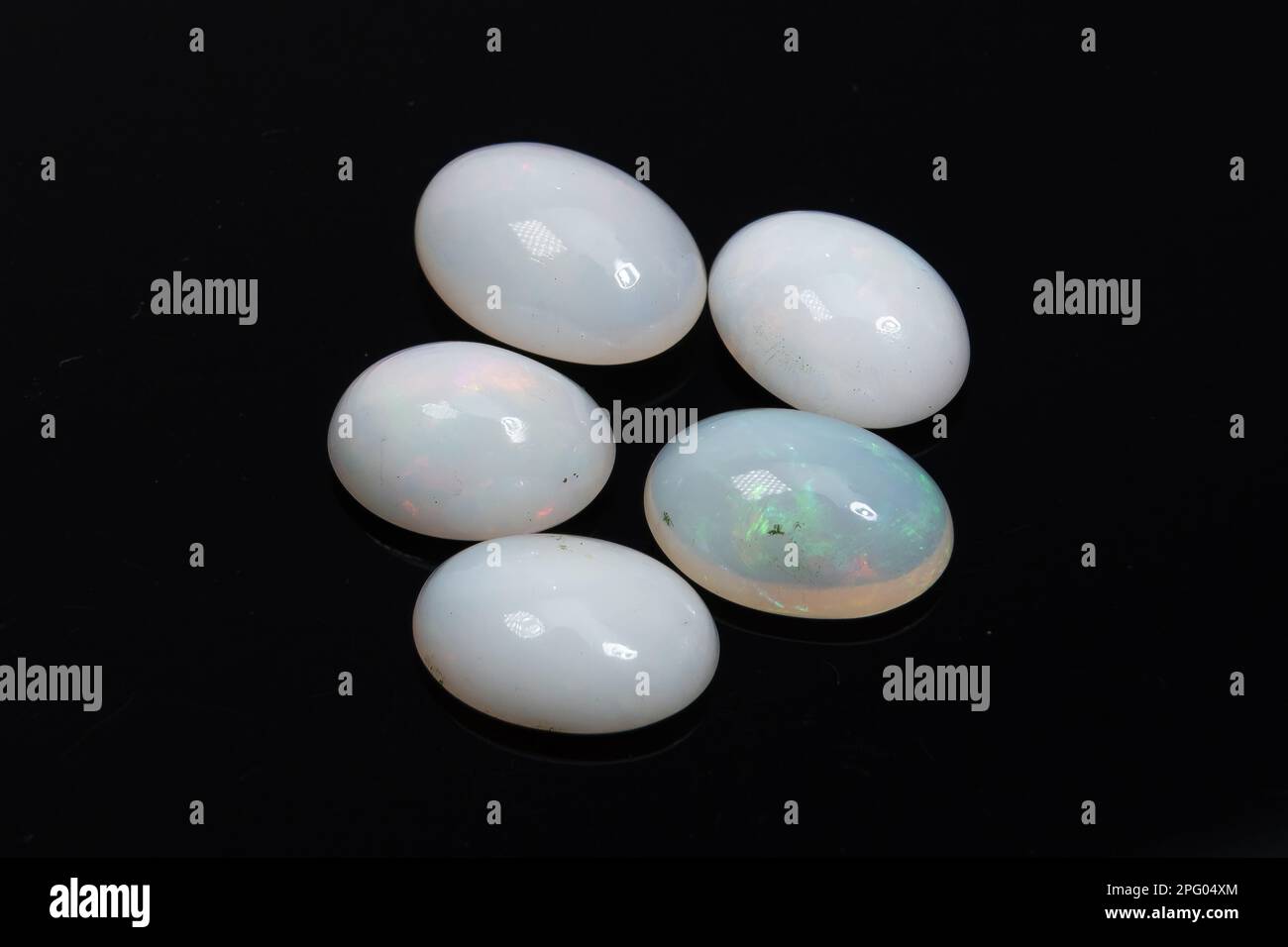 Natural precious stone noble opal on a black background Stock Photo