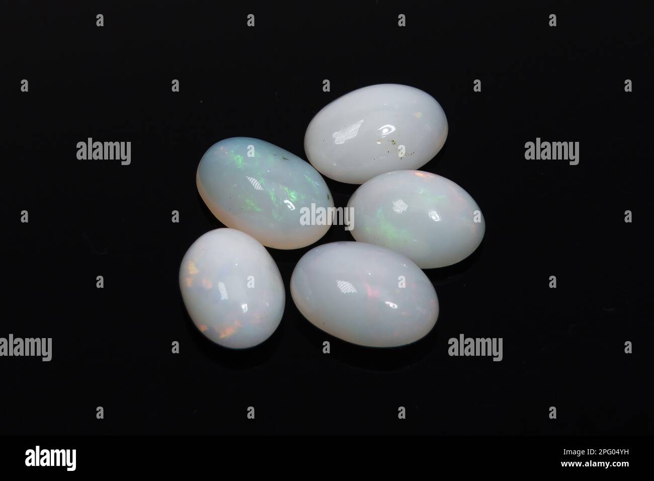 Natural precious stone noble opal on a black background Stock Photo