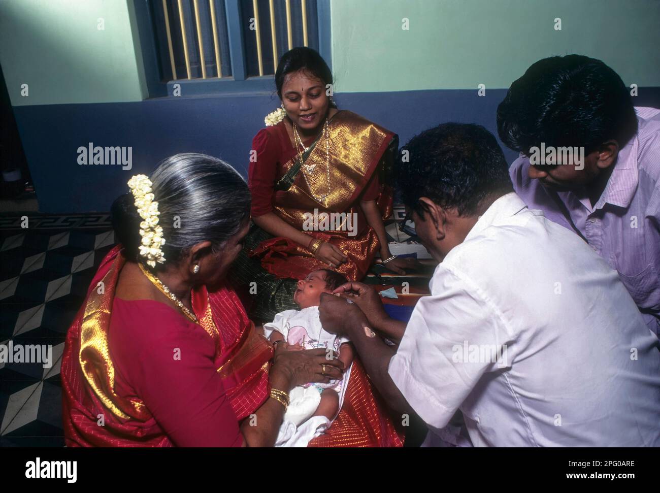 Traditionel ear boring ceremony at baby, usually in the maternal grandparent's home, Chettinad, Tamil Nadu, India Stock Photo