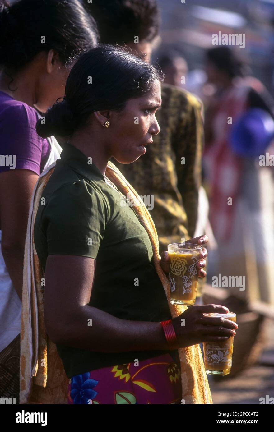 A woman tea server in Vizhinjam, a fishing village near Thiruvananthapuram; Trivandrum, Kerala, India Stock Photo