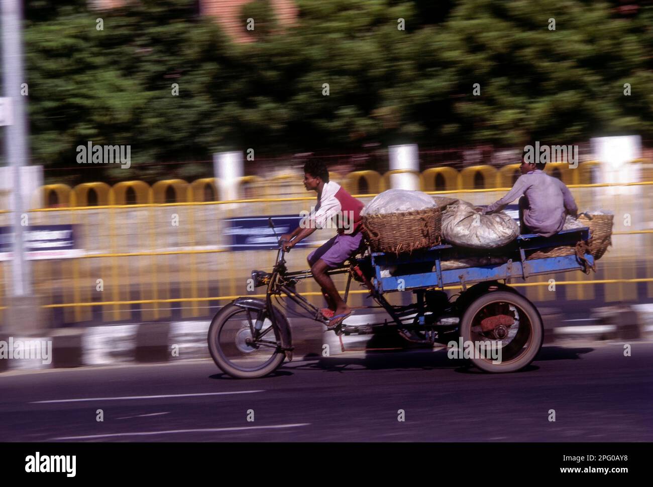 People journeying on a tricycle on the beach road in Chennai, Tamil Nadu, India, Asia Stock Photo