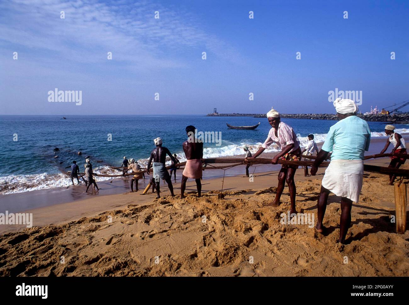 Fishermen hauling the fishing nets in Vizhinjam near Thiruvananthapuram, Kerala, India, Asia Stock Photo