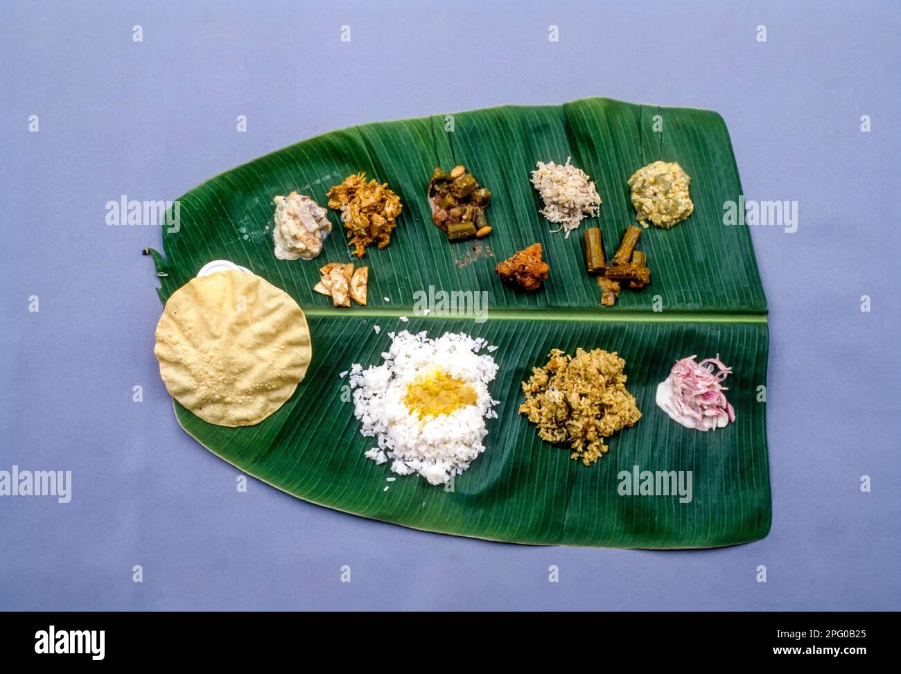 A banana leaf, wedding vegetarian lunch of Nattukottai Chettiar; Nagarathar Community, Chettinad, Tamil Nadu, India Stock Photo
