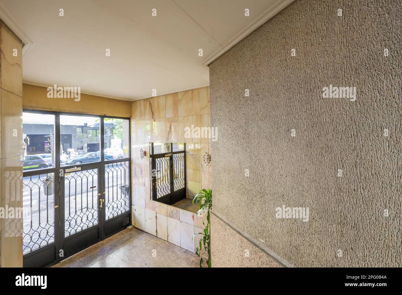 Portal of an urban residential housing building with black metal doors